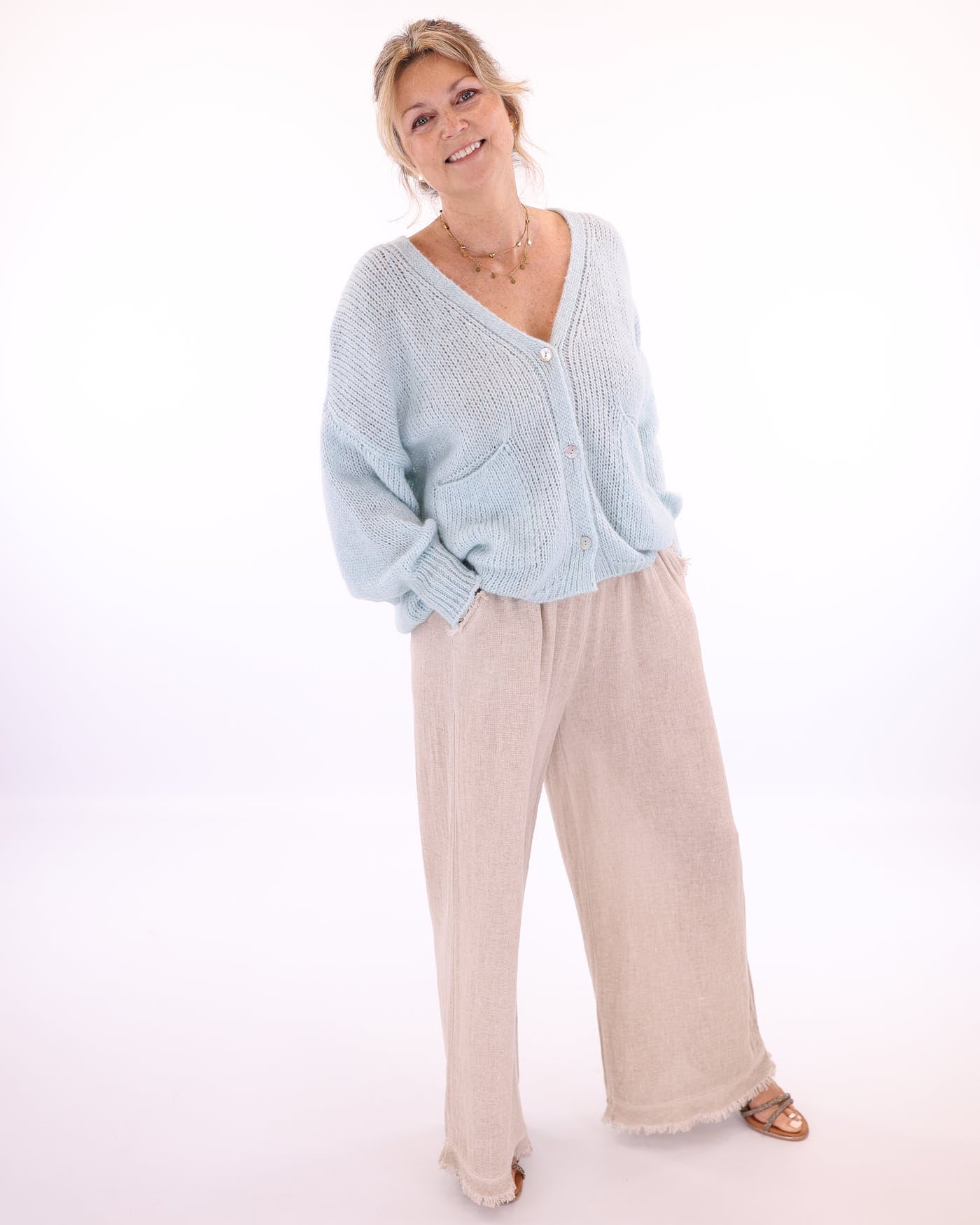 Women's long sleeve V neck alpaca blend knitted cardigan with front patch pockets and three buttons in pale blue, made in Italy