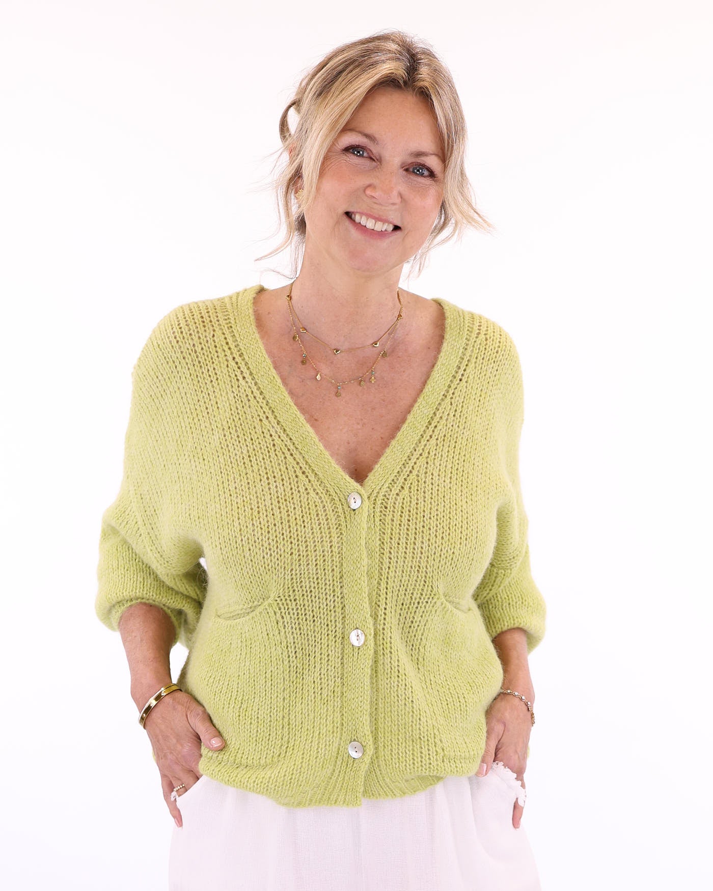 Women's long sleeve V neck alpaca blend knitted cardigan with front patch pockets and three buttons in light green, made in Italy