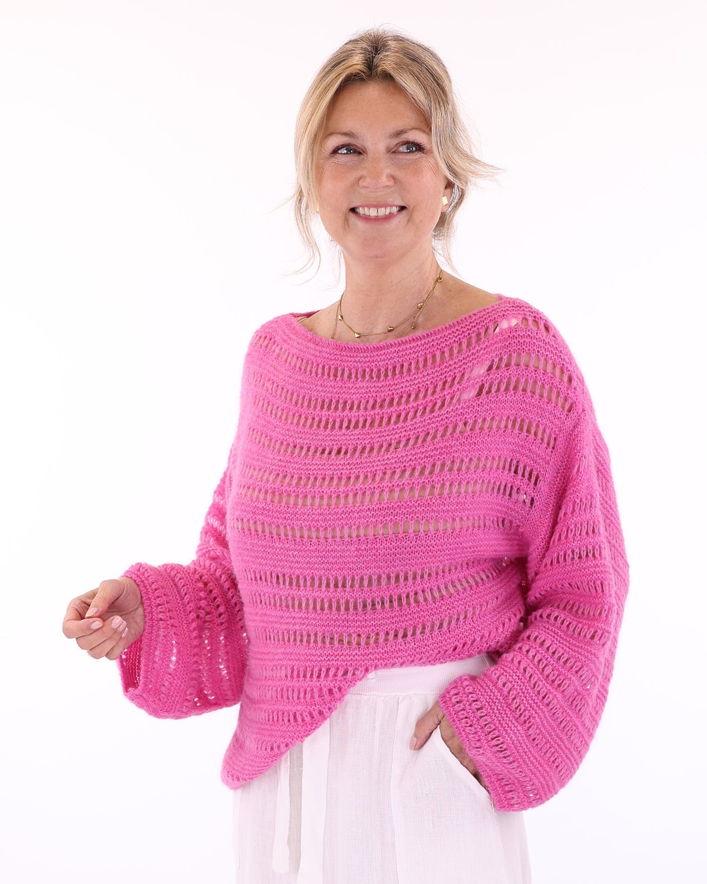 Women's alpaca blend fuchsia pink crochet style long sleeve jumper on a white background, made in Italy