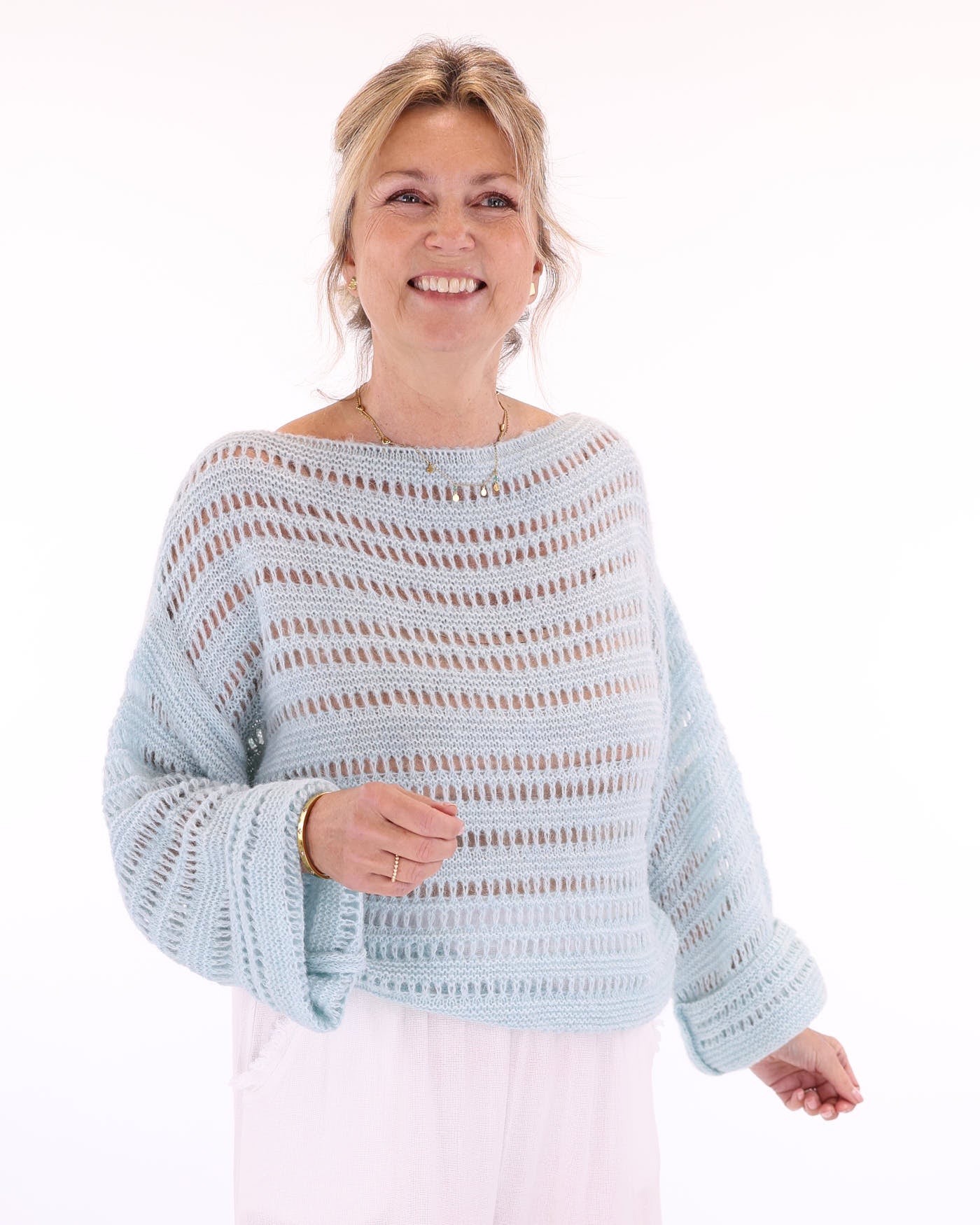 Women's alpaca blend light blue crochet style long sleeve jumper on a white background, made in Italy
