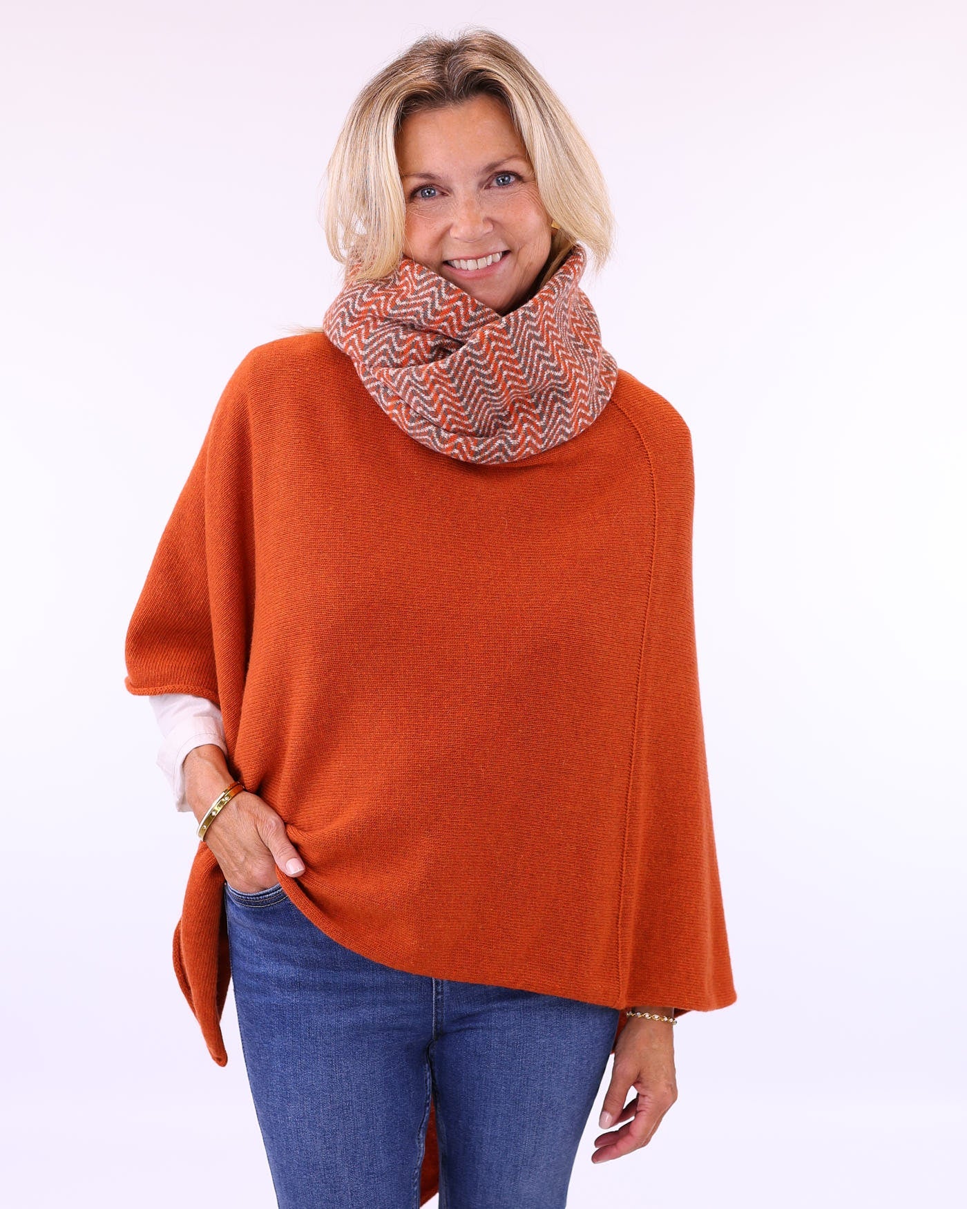 Women's cashmere blend poncho in burnt orange, worn with multi colour cashmere blend snood, made in Italy