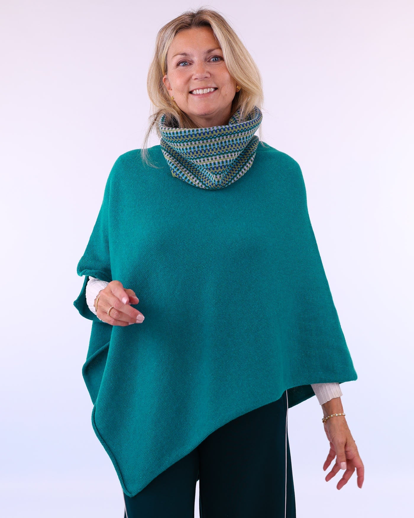 Women's cashmere blend poncho in teal blue, worn with multi colour cashmere blend snood, made in Italy