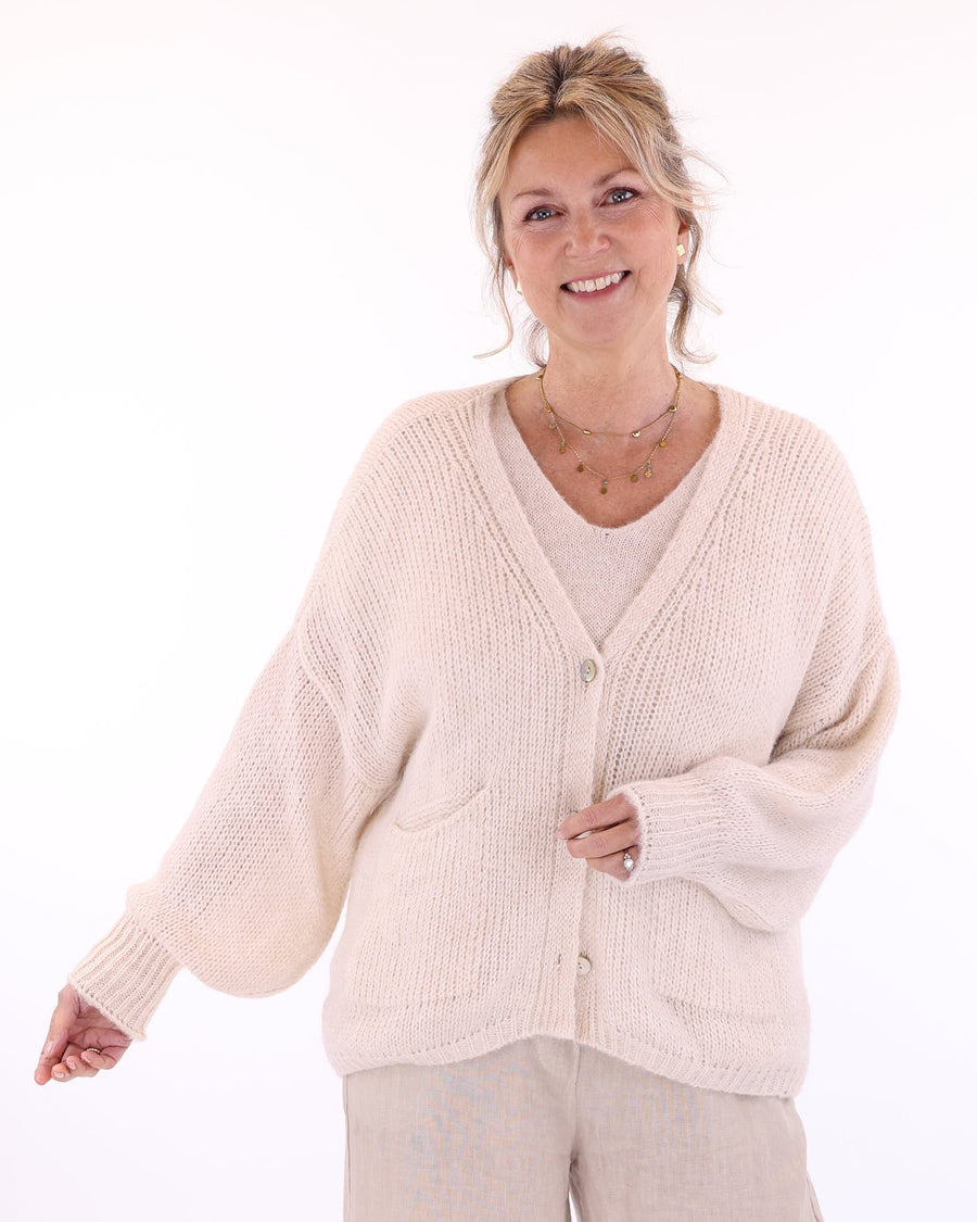 Women's long sleeve V neck alpaca blend knitted cardigan with front patch pockets and three buttons in cream, made in Italy